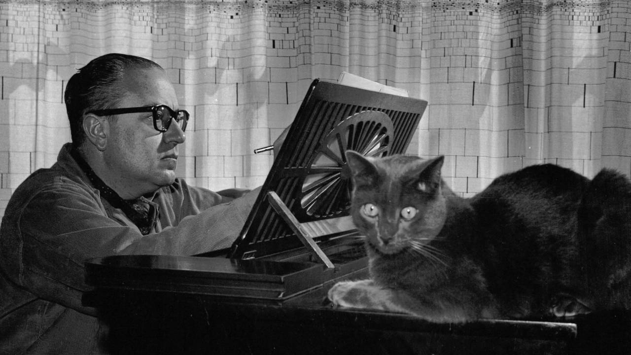 Alberto Ginastera and cat at piano