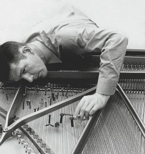 John Cage preparing a piano circa 1950