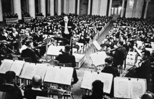 Karl Eliasberg conducting the starving Leningrad Radio Orchestra to a starving audience in a performance of Shostakovich’s Symphony No, 7 on August 9, 1942