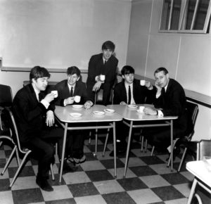 The Beatles taking a break while recording their first full album, February 11, 1963: left-to-right, John Lennon, Ringo Starr, George Harrison, Paul McCartney, and George Martin