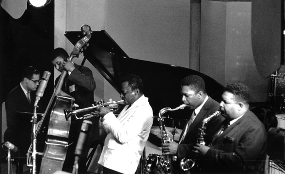 Miles Davis Sextet performing live circa 1959; left-to-right Bill Evans, Paul Chambers, Miles Davis, John Coltrane, Julian “Cannonball” Adderley; not in photo, Jimmy Cobb