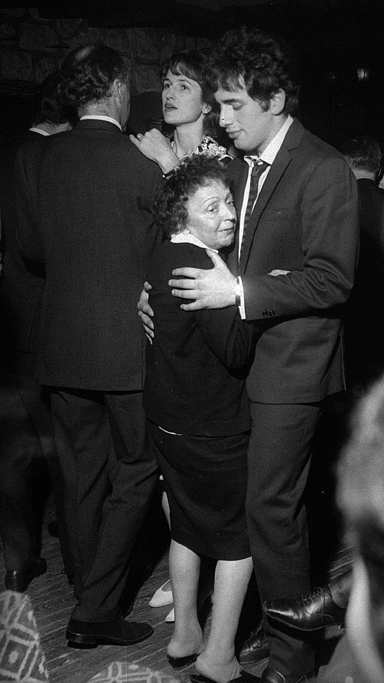 Édith Piaf in 1962, a year before her death, with her second (and last) husband, a singer, actor, and former hairdresser named Theo Sarapo (born Theophanis Lamboukas, 1936-1970). He was more than twenty years her junior. 