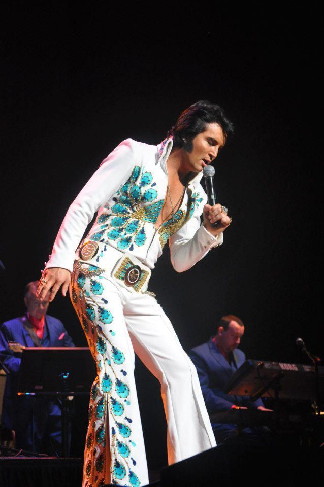 Elvis Presley (1935-1977) wearing his peacock jumpsuit in concert, circa 1974