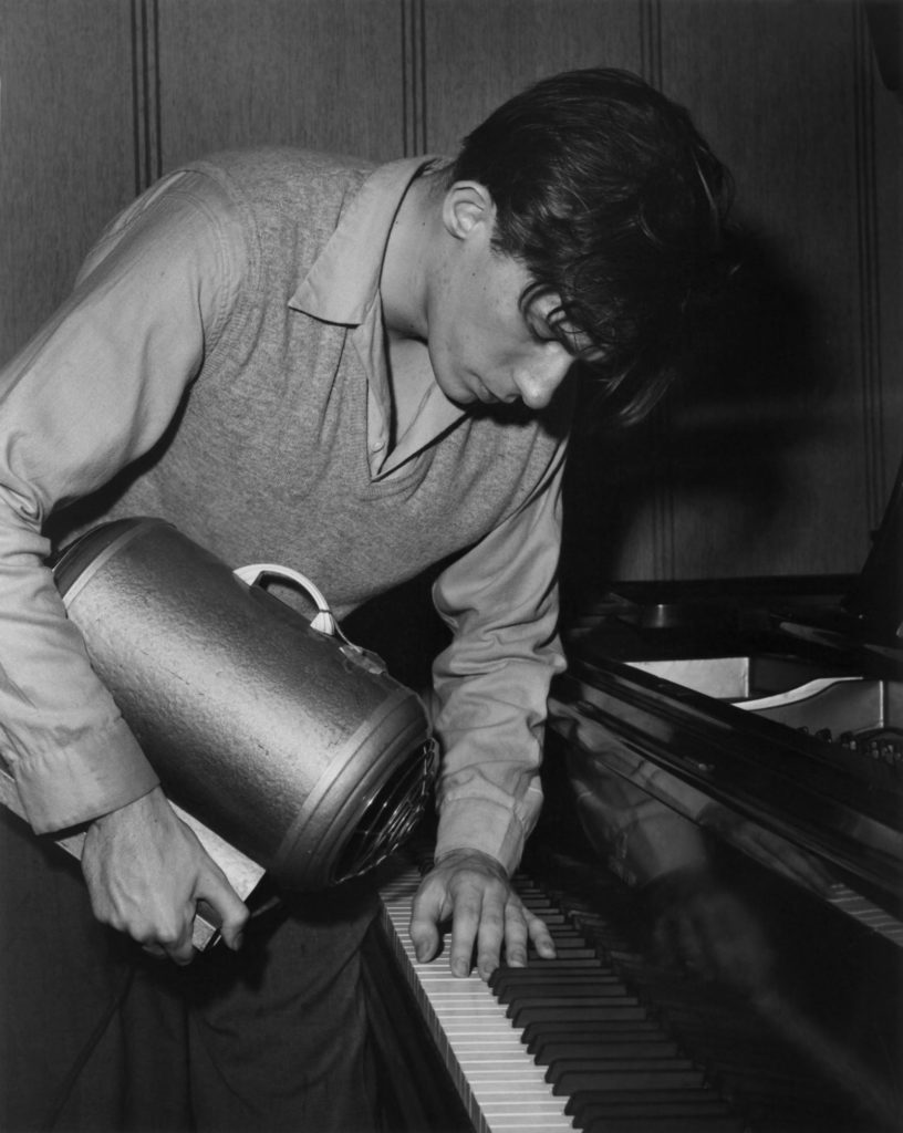 Glenn Gould in 1957, warming his always-cold hands and piano keys, in a photo by Yousuf Karsh