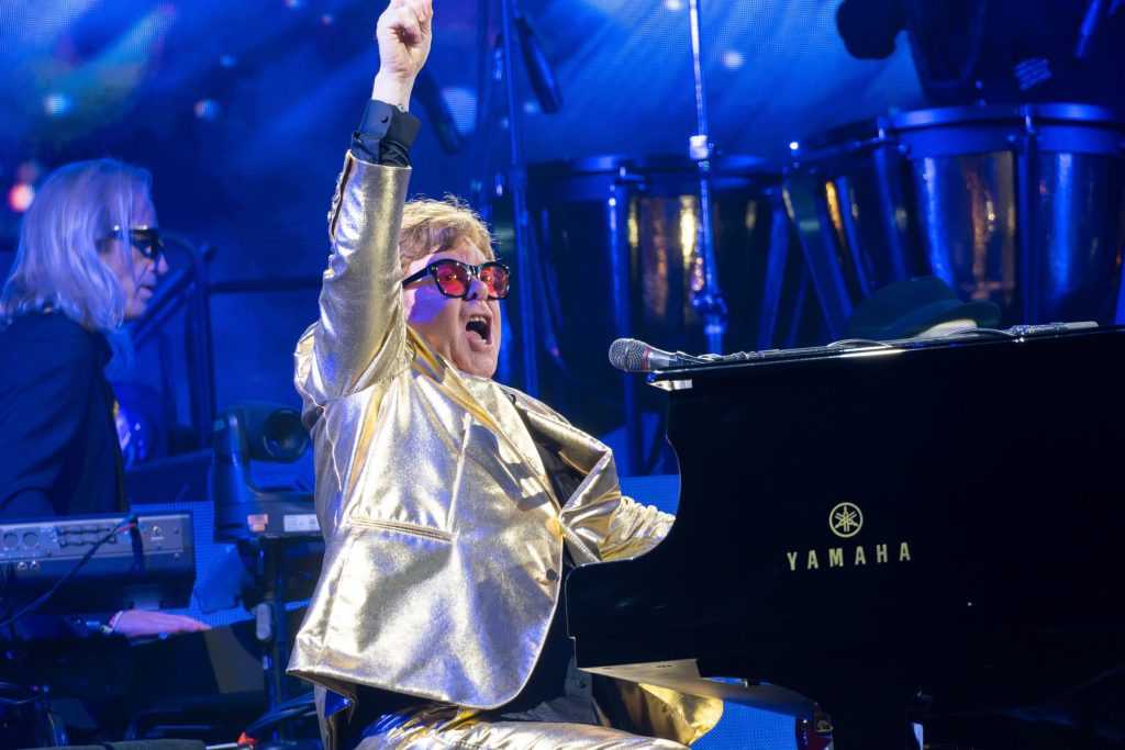 Elton Hercules John (born Reggie Kenneth Dwight; March 25, 1947) performing at the Glastonbury Festival in June 2023, during the last leg of his “Farewell Yellow Brick Road: The Final Tour”